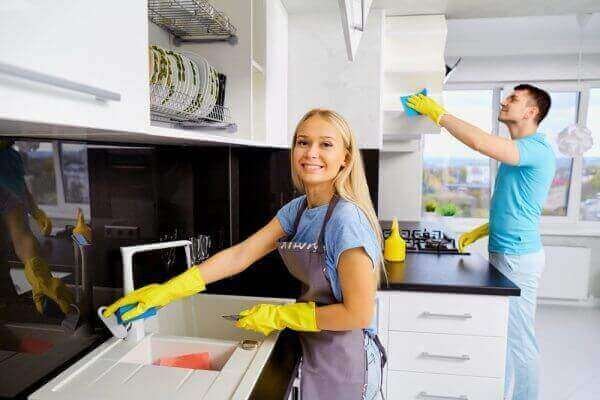 Couple cleaning kitchen together